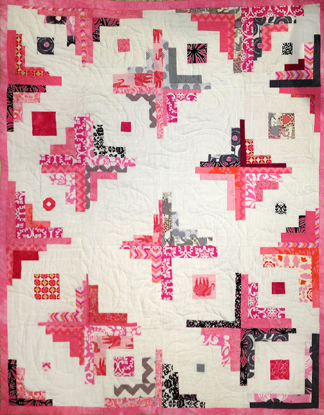 Victoria's Quilt. 40" x 50" commercial and hand-dyed cottons. "Converging Corners" block.